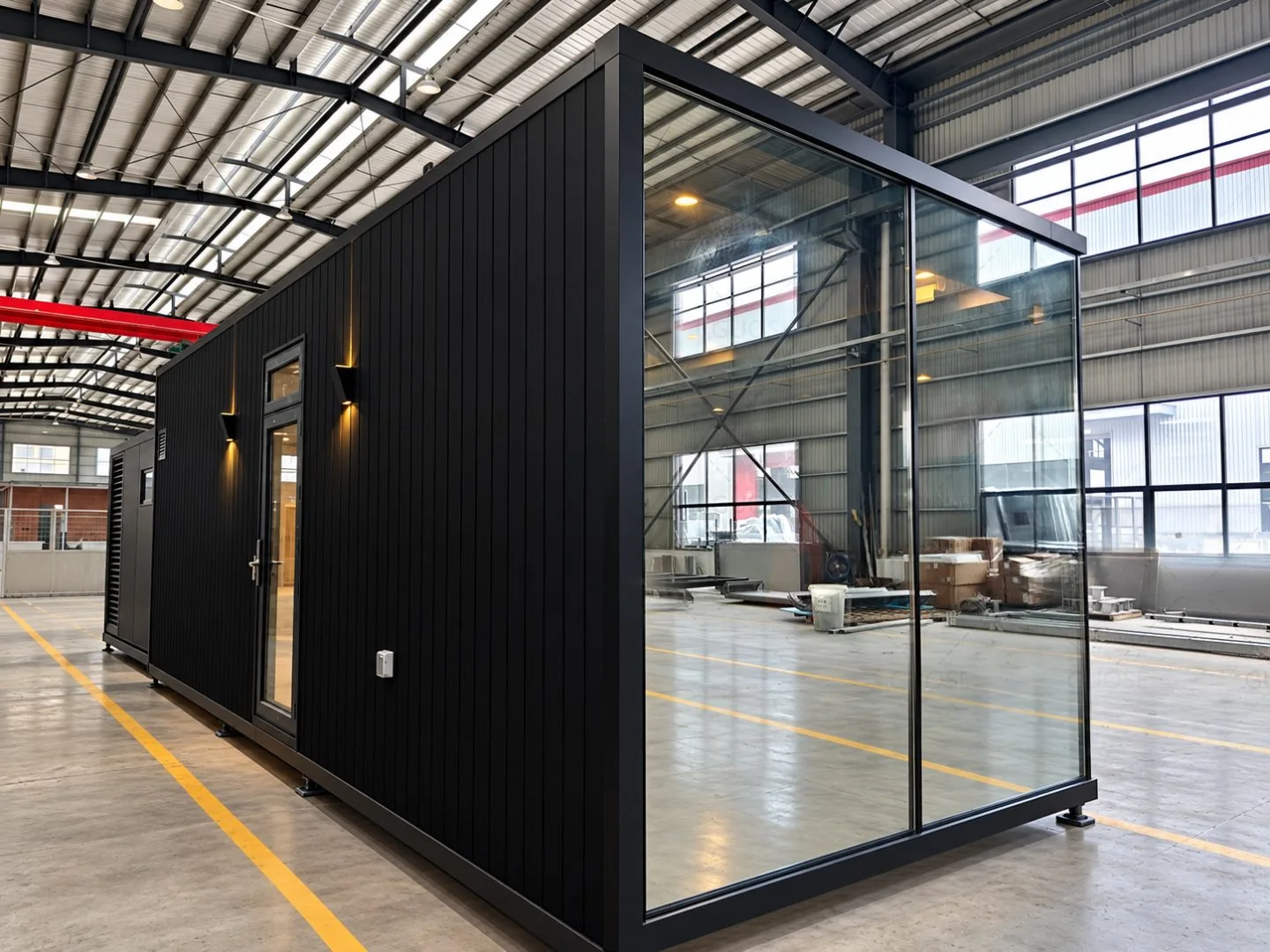 Completed black modular home inside the MAVE factory